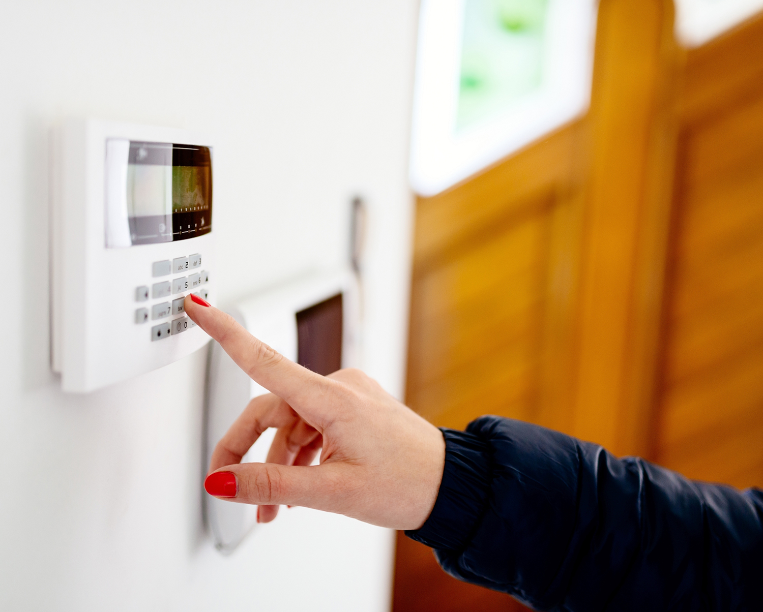 Woman using keypad in entryway