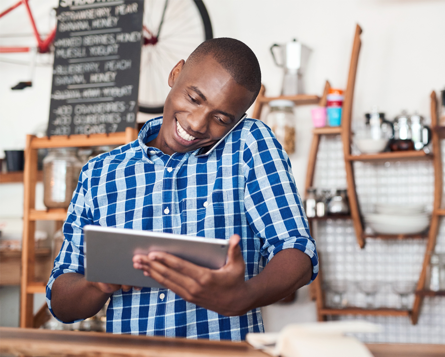 Business owner multitasking on phone and tablet