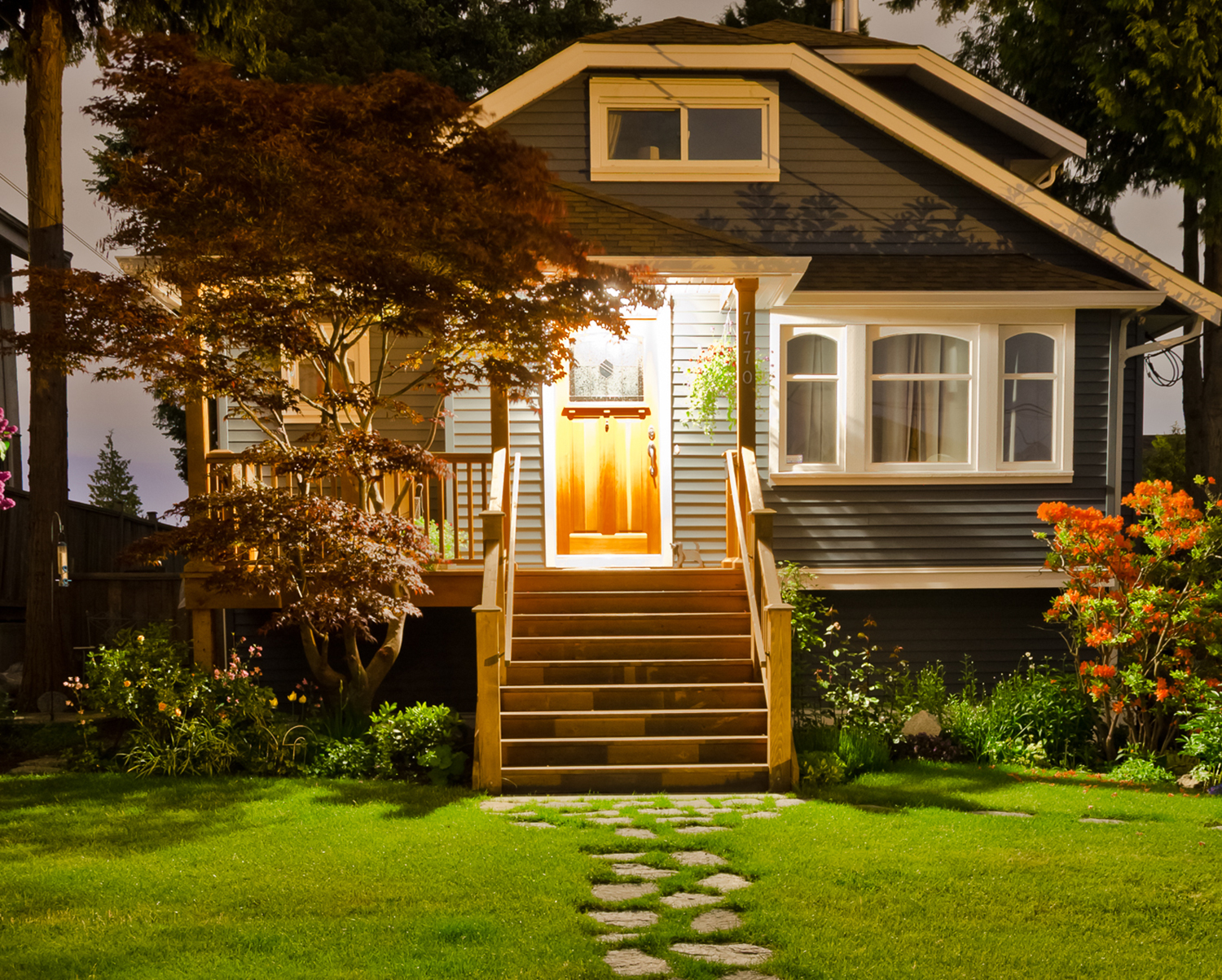 Home with front porch lit at night