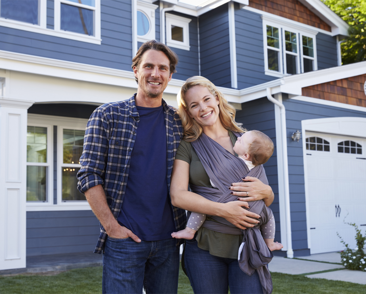 Family of 3 in front of home