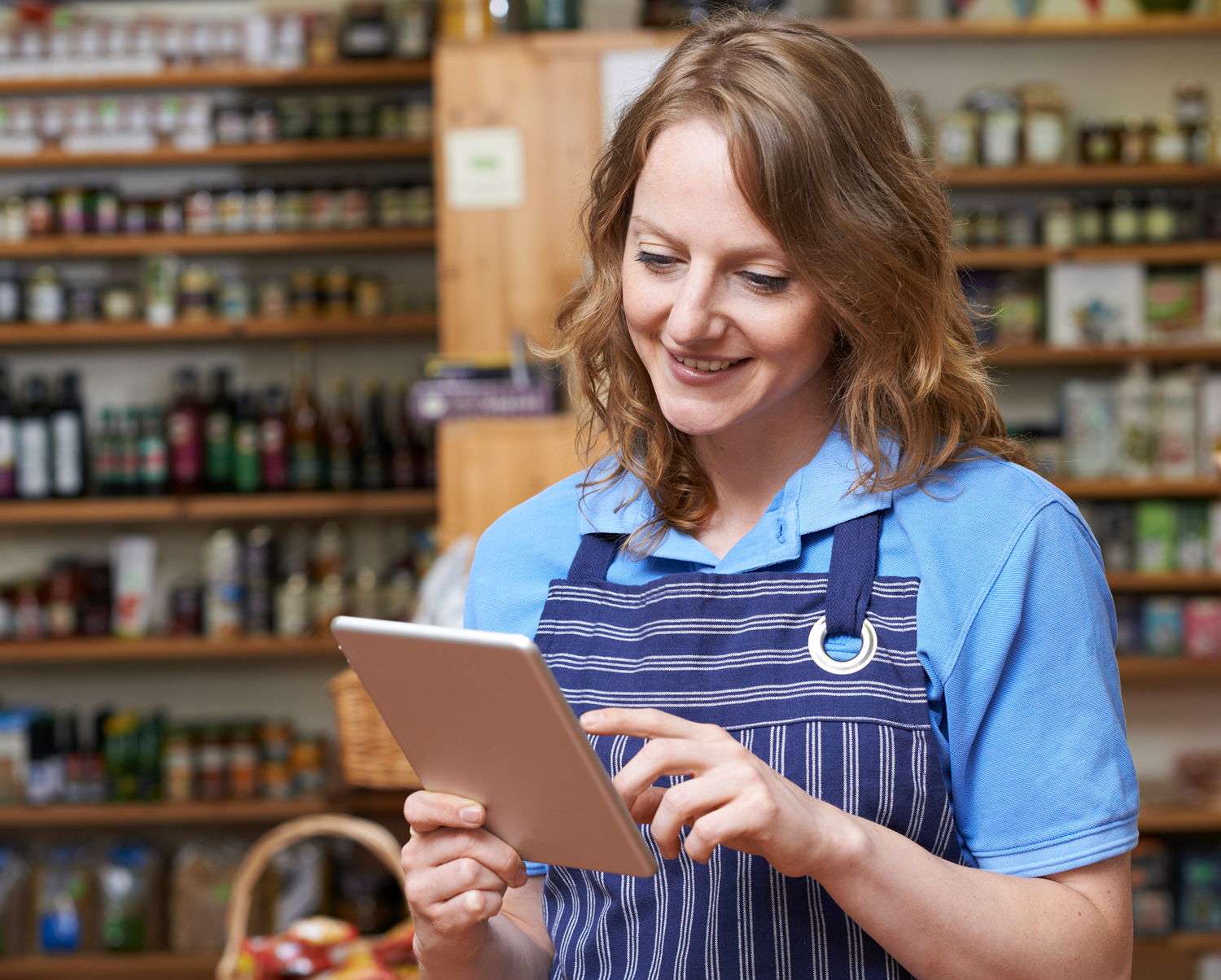 Business owner using tablet to monitor security