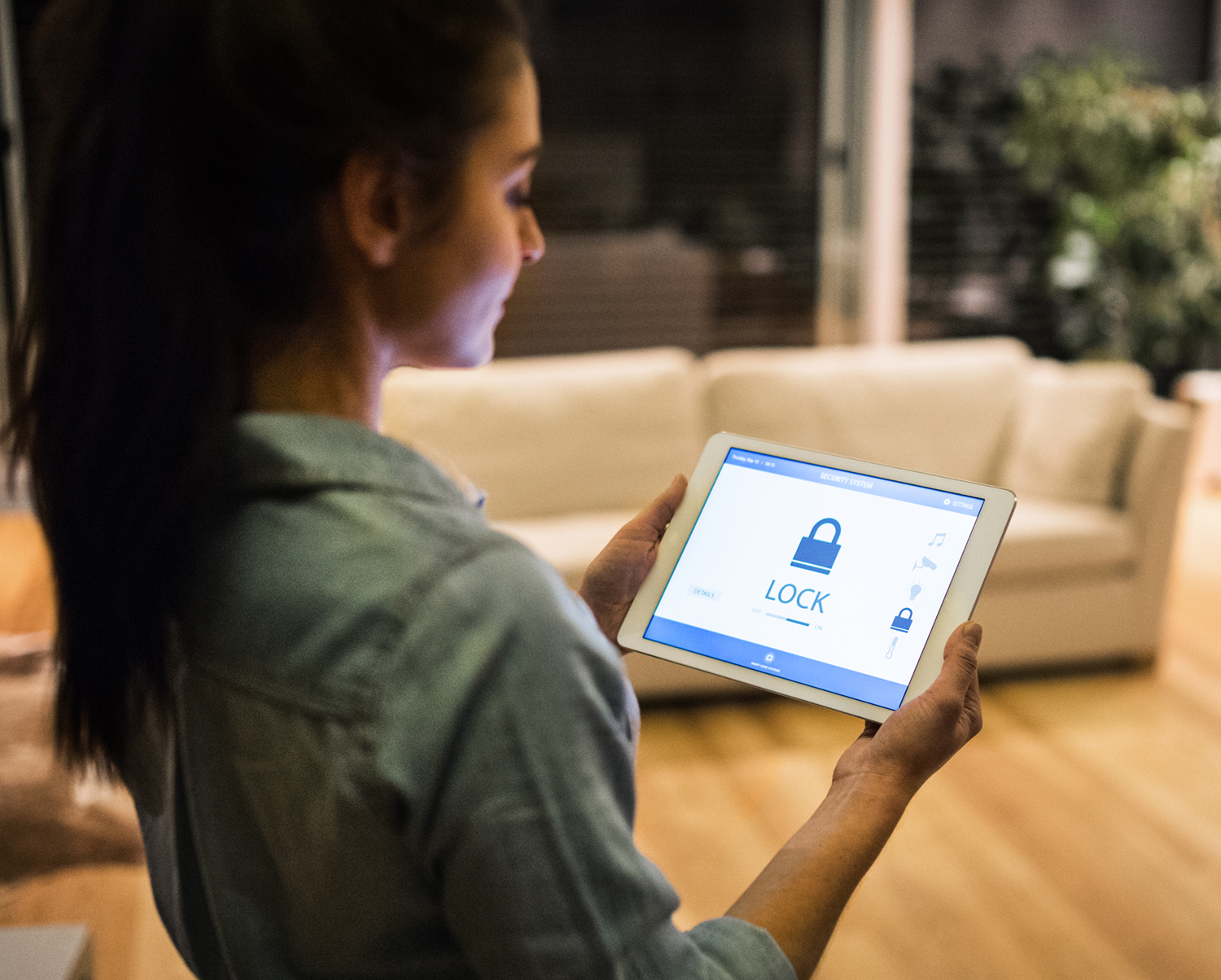 Woman using tablet to secure home