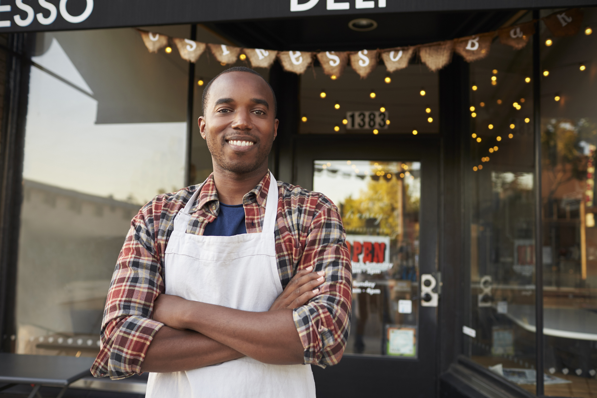 Business owner standing in front of store